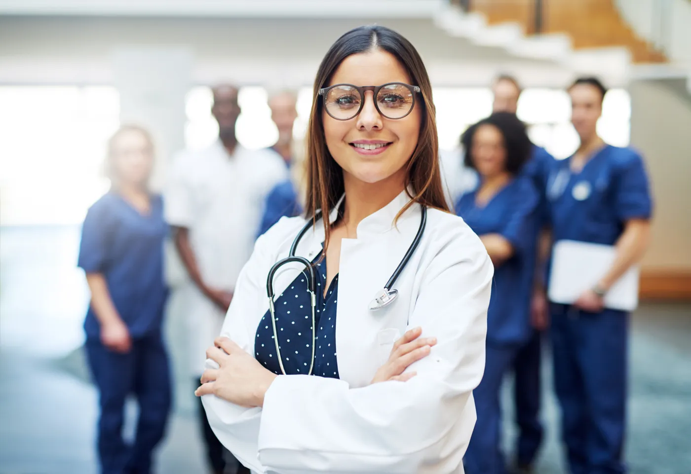 Smiling physician in front of her team at the clinic